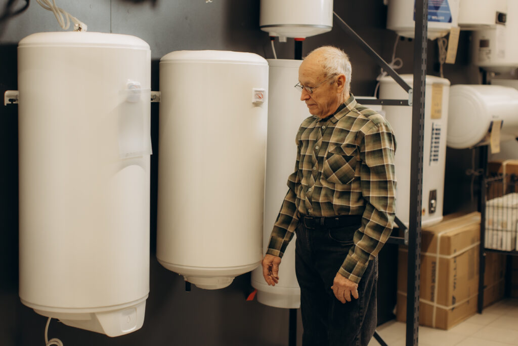 Senior man choosing water heater in hardware store